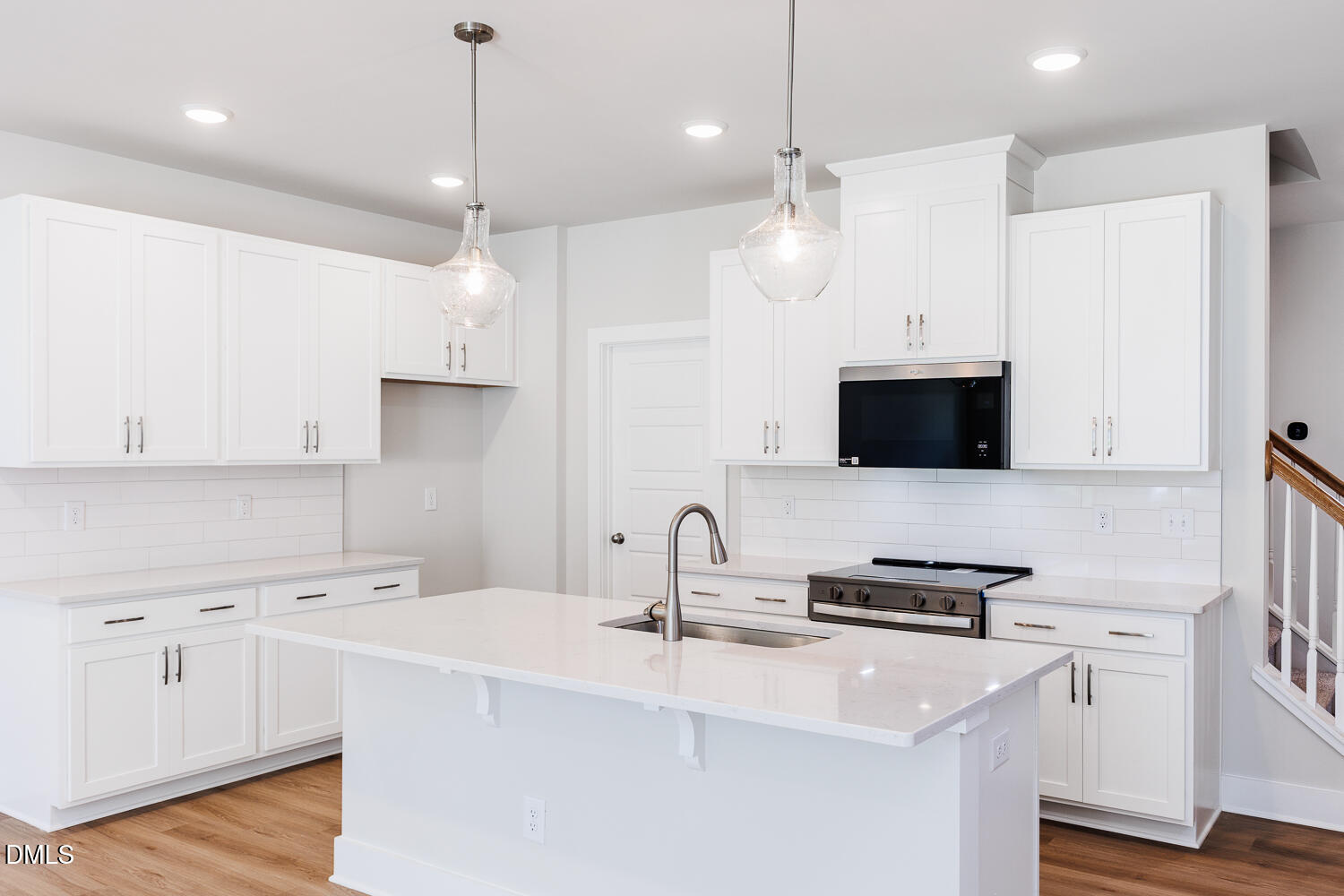 133 Silver Pne Drive Angier, NC 27501 - Photo 24 of 51 a kitchen with stainless steel appliances a stove sink and white cabinets