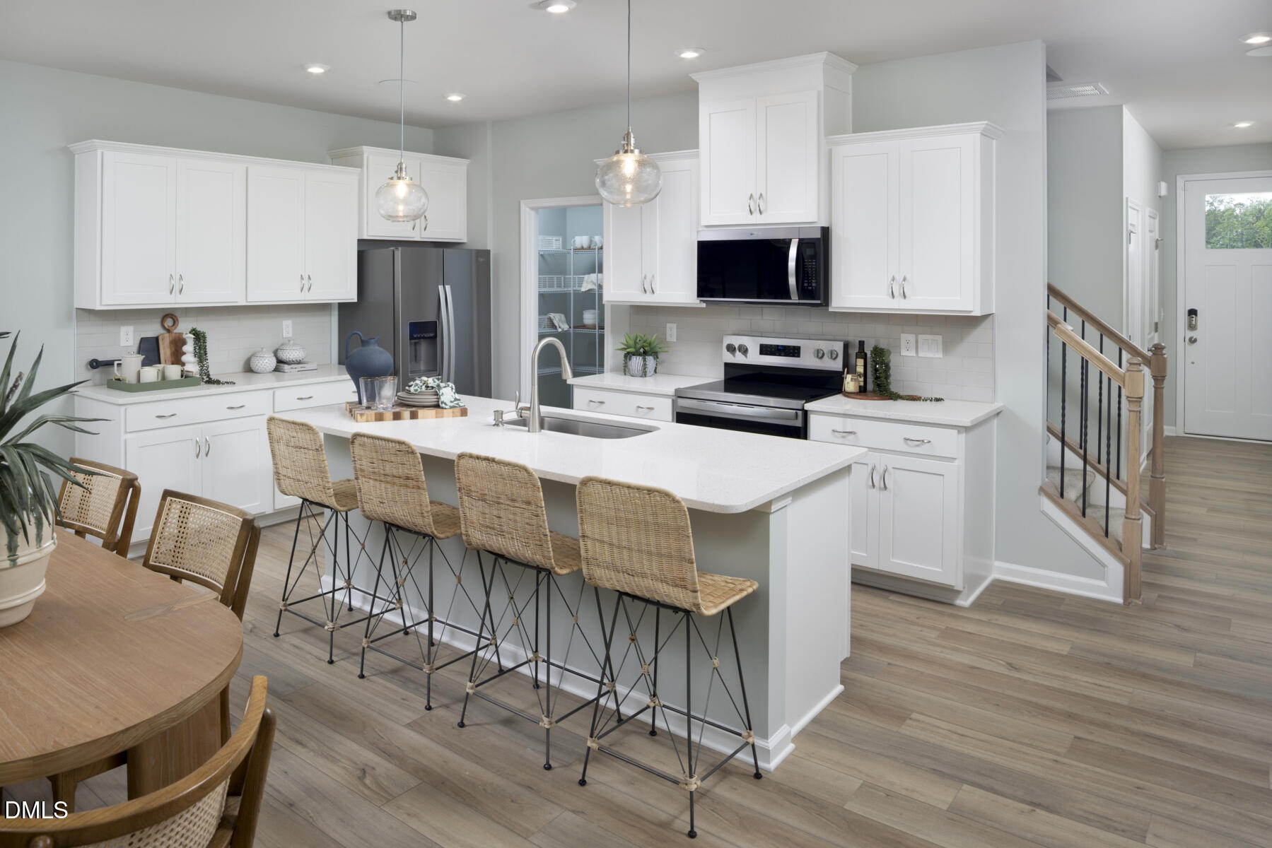 133 Silver Pne Drive Angier, NC 27501 - Photo 7 of 51 a kitchen with stainless steel appliances kitchen island granite countertop a stove a sink a microwave a refrigerator and white cabinets