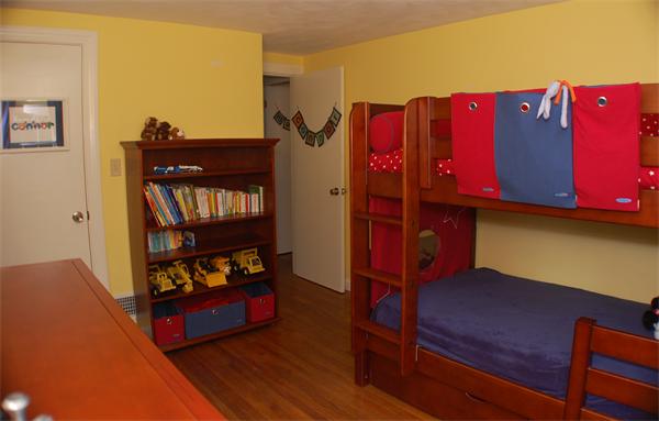 86 Arch Street Needham, MA 02492 - Photo 13 of 24 a bedroom with a bed and furniture