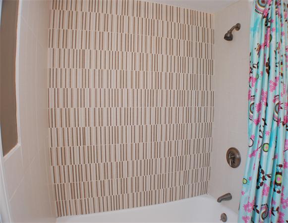 86 Arch Street Needham, MA 02492 - Photo 18 of 24 a bathroom with a shower curtain