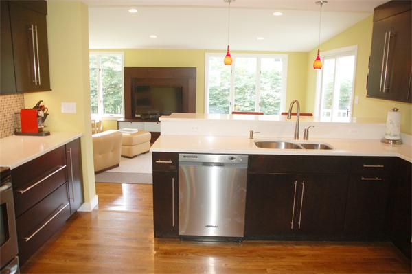 86 Arch Street Needham, MA 02492 - Photo 3 of 24 a kitchen with stainless steel appliances granite countertop a sink a stove and a microwave