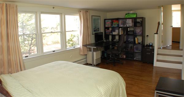 86 Arch Street Needham, MA 02492 - Photo 8 of 24 a bed sitting in a bedroom next to a window