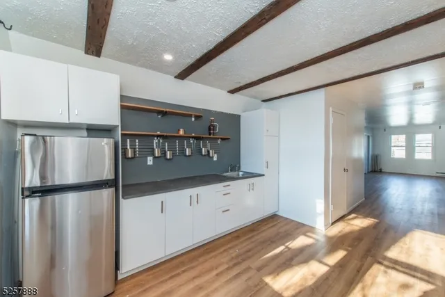 a kitchen with granite countertop a refrigerator and a stove