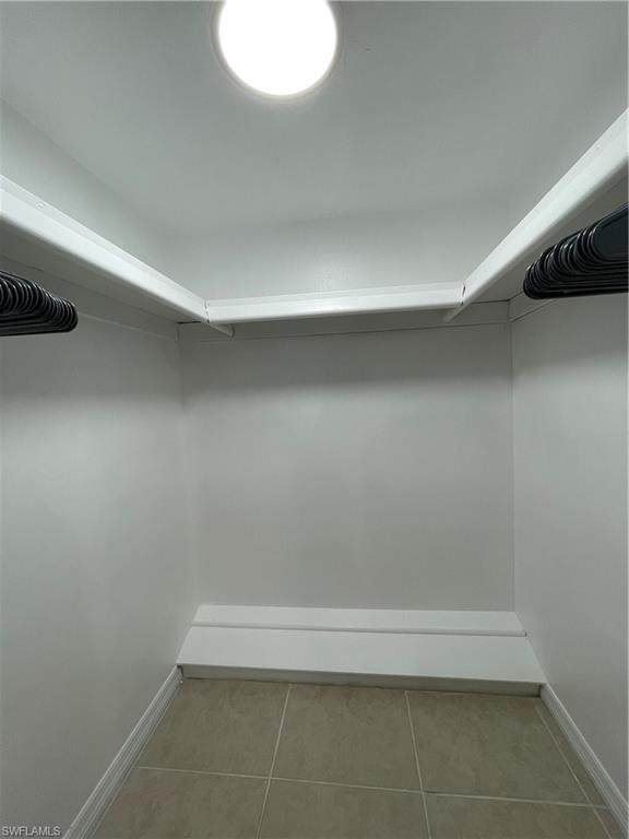 170 Turtle Lake Court, Unit 103 Naples, FL 34105 - Photo 20 of 37 Walk in closet with light tile patterned floors