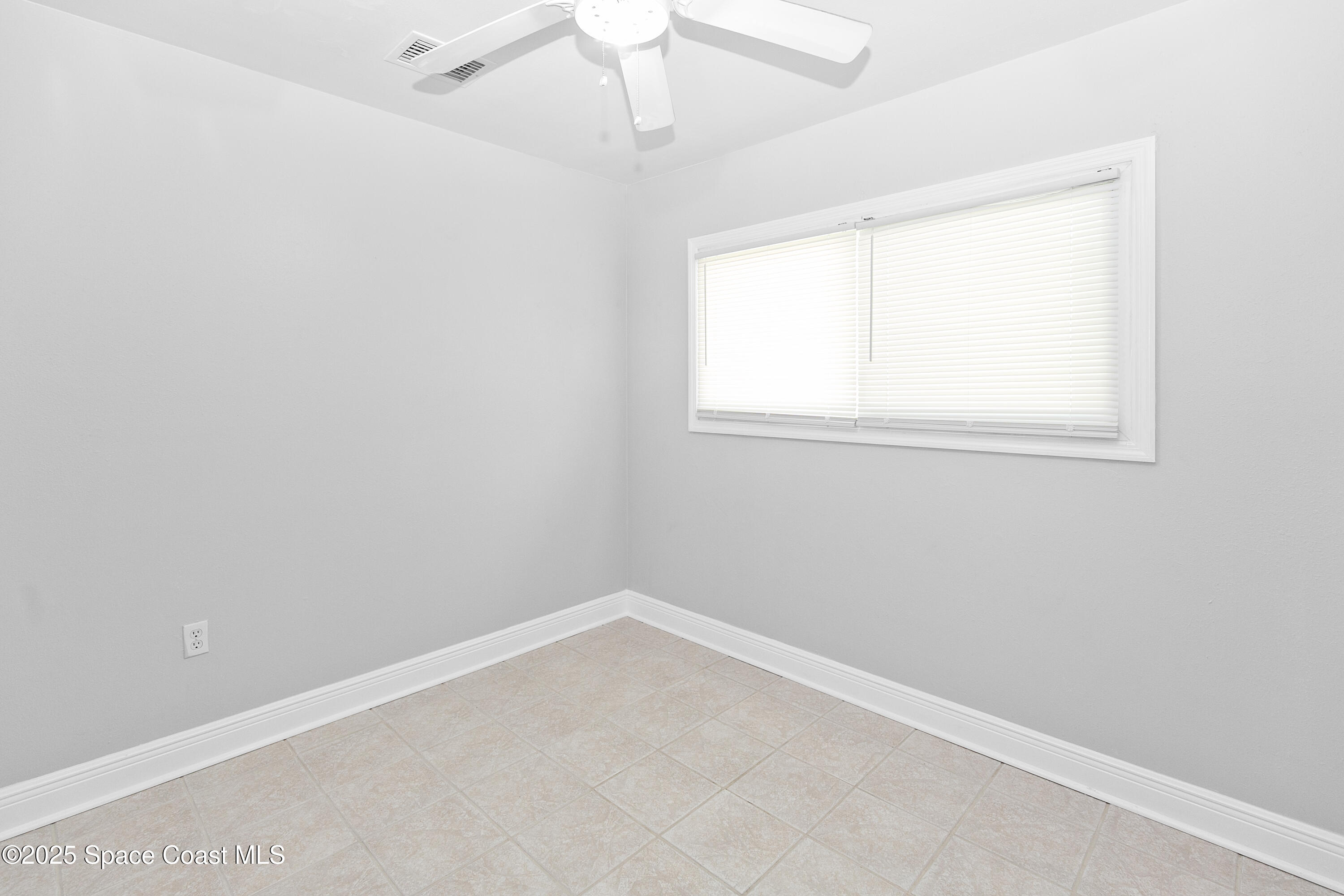 905 North Carpenter Road Titusville, FL 32796 - Photo 13 of 27 an empty room with a window