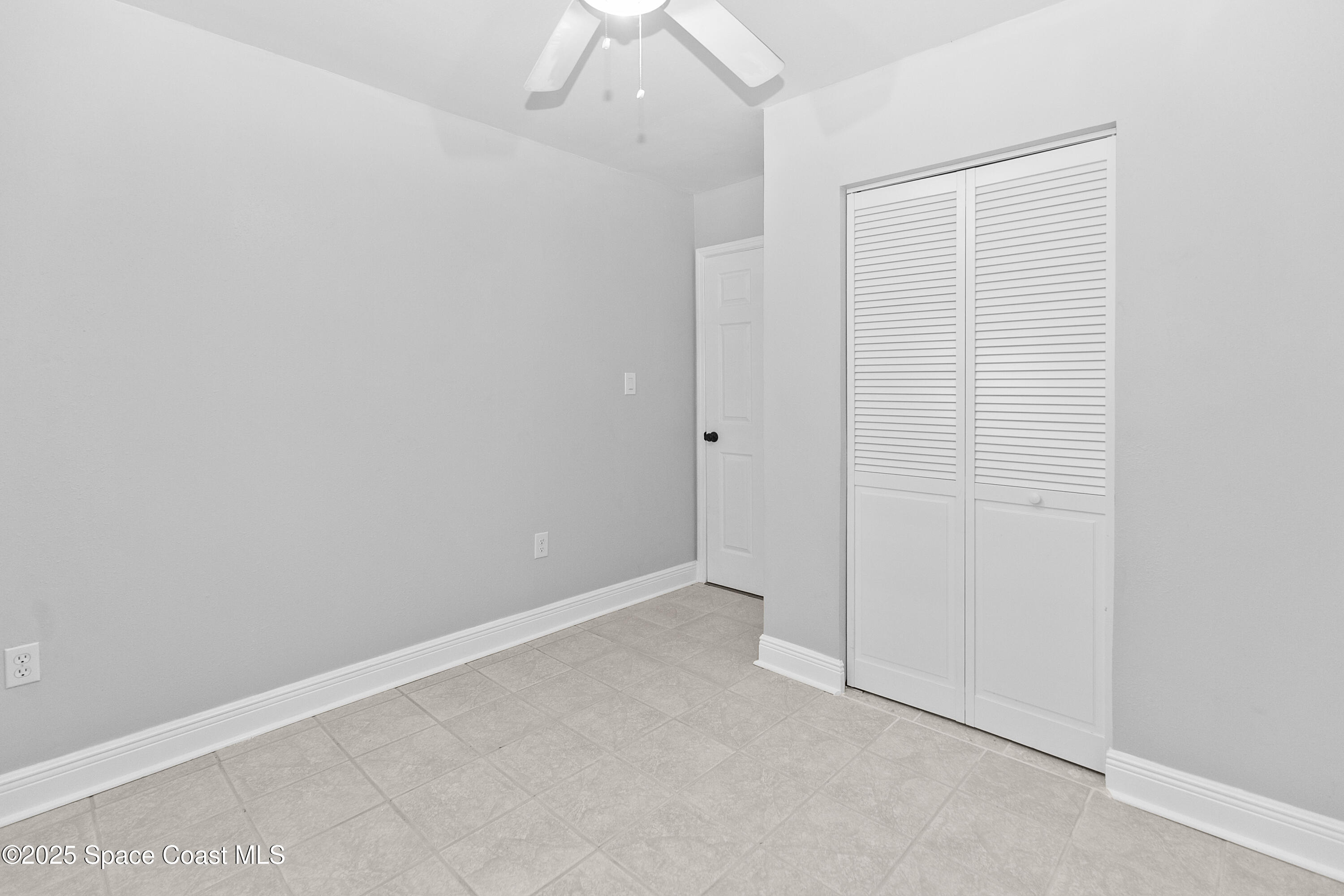 905 North Carpenter Road Titusville, FL 32796 - Photo 15 of 27 an empty room with a ceiling fan