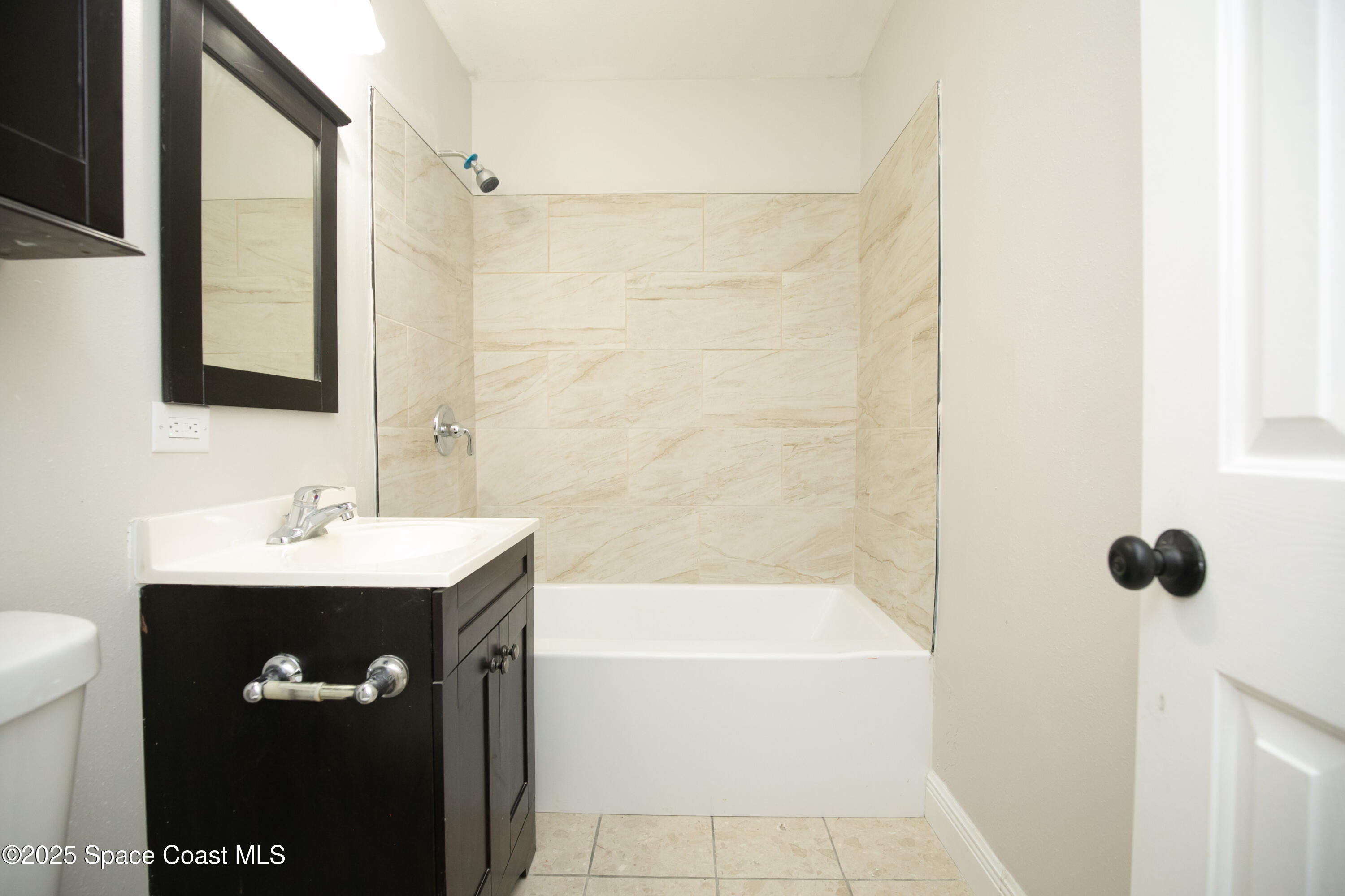 905 North Carpenter Road Titusville, FL 32796 - Photo 16 of 27 a bathroom with a bathtub and a sink