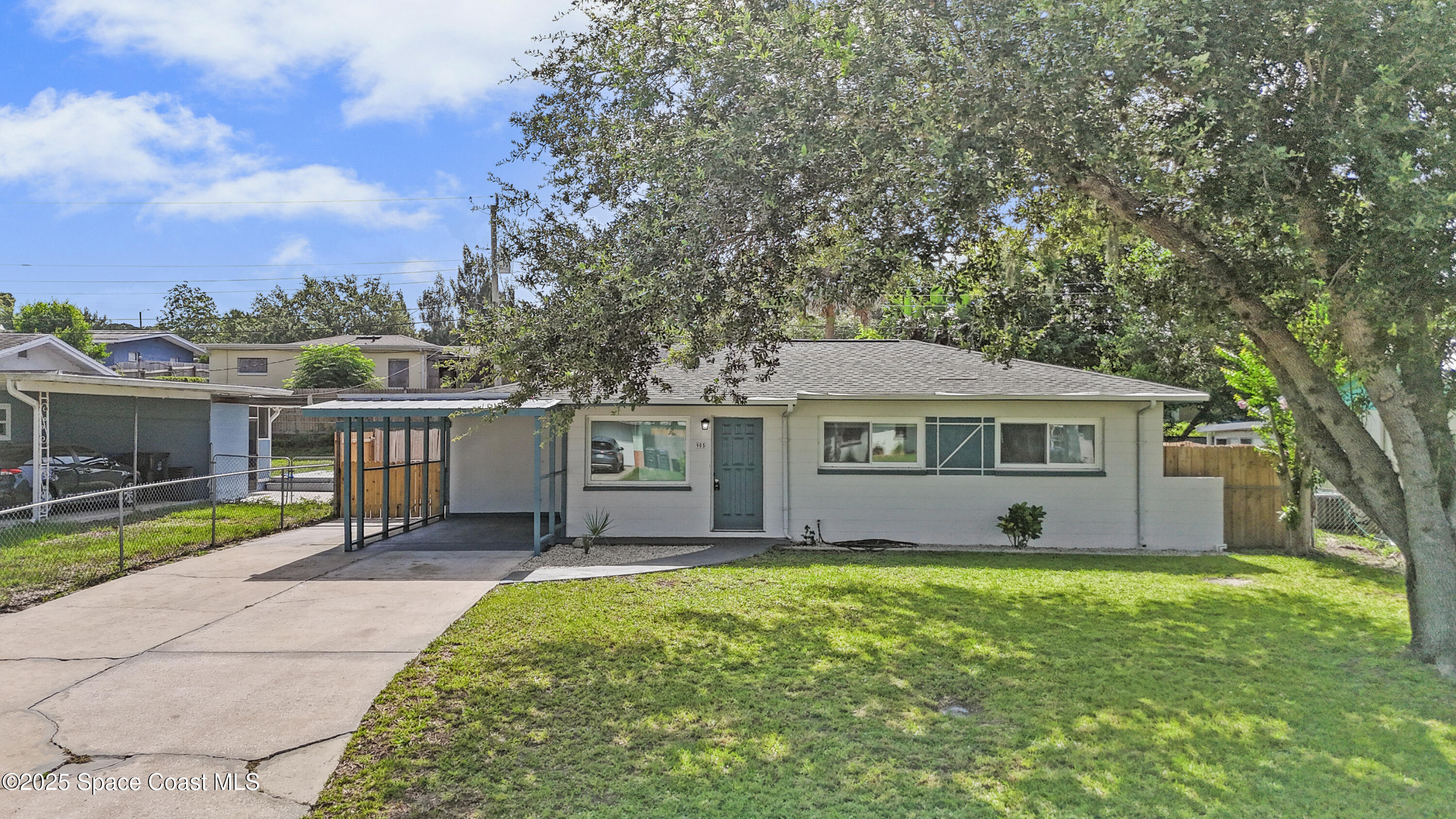 905 North Carpenter Road Titusville, FL 32796 - Photo 2 of 27 a view of a house with a yard