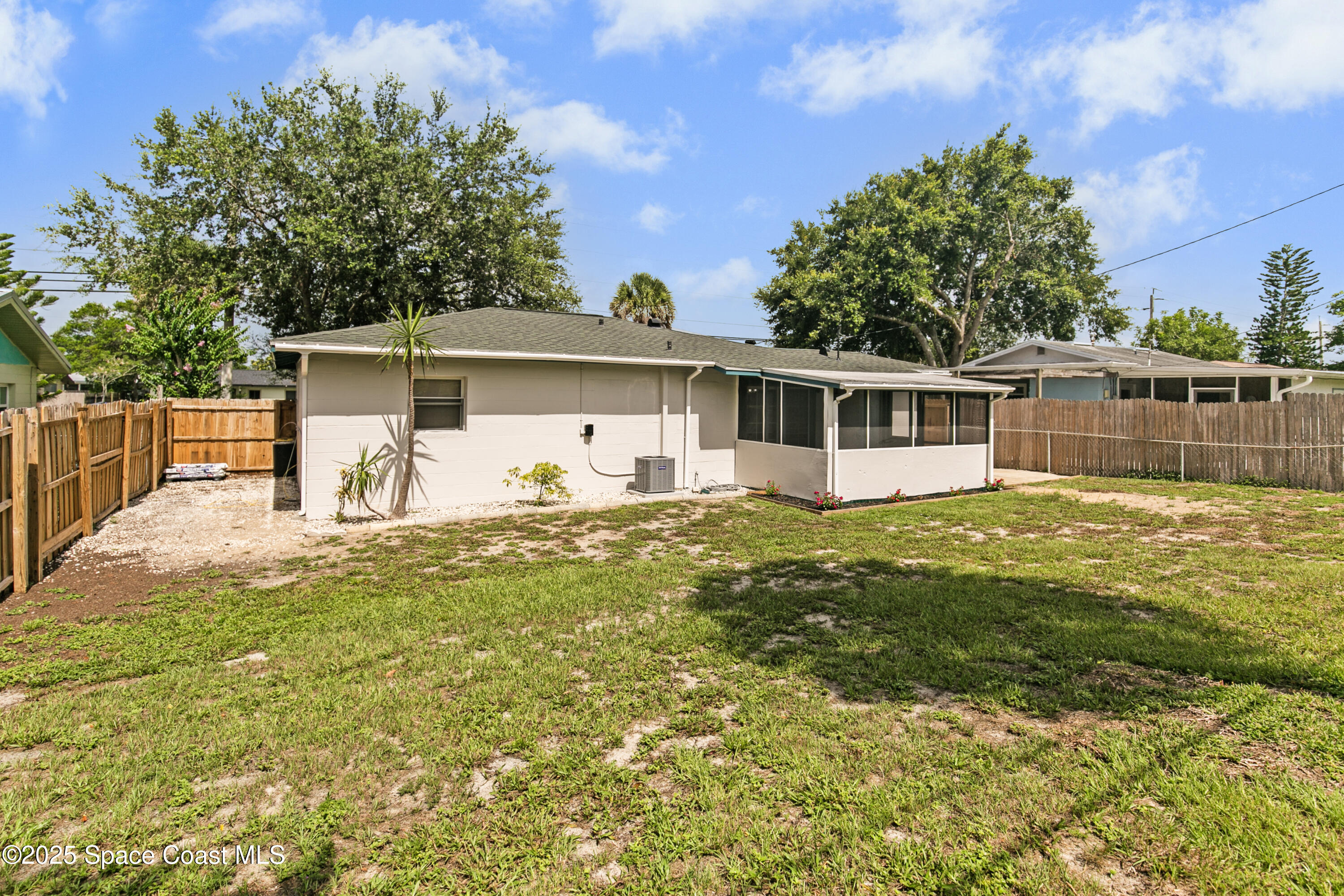 905 North Carpenter Road Titusville, FL 32796 - Photo 23 of 27 a view of a house with pool and chairs next to a yard