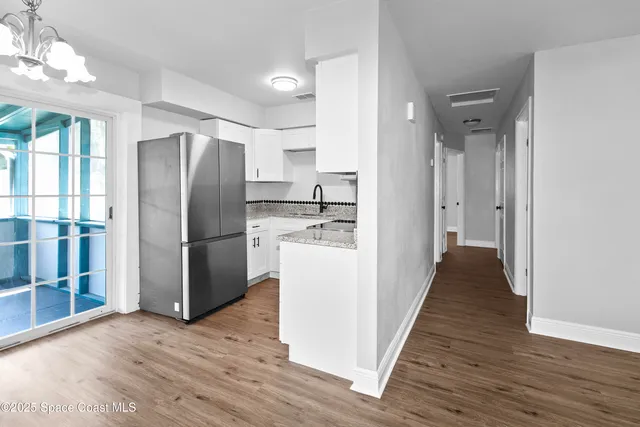 a kitchen with stainless steel appliances a refrigerator and a stove top oven