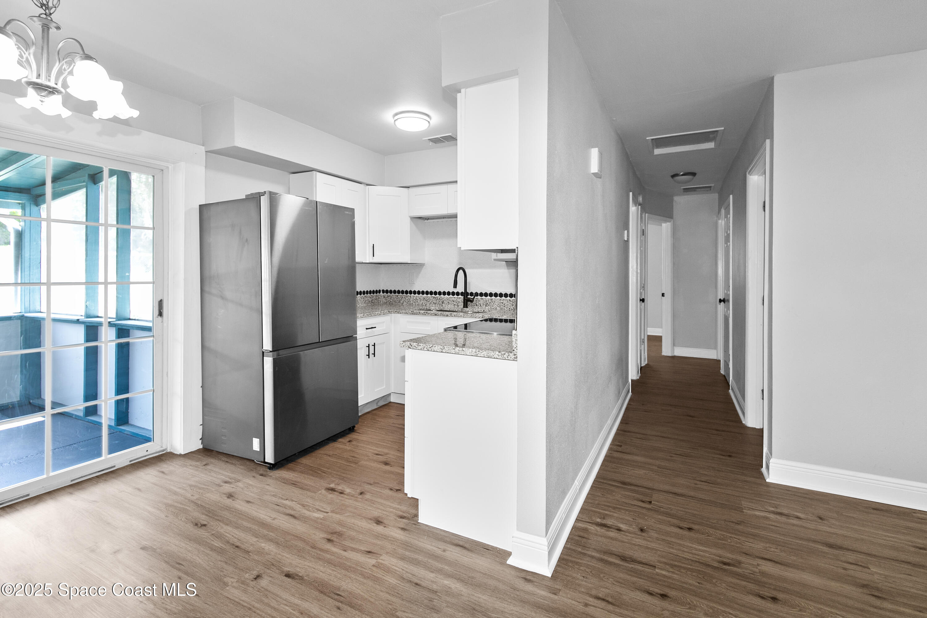 905 North Carpenter Road Titusville, FL 32796 - Photo 8 of 27 a kitchen with stainless steel appliances a refrigerator and a stove top oven