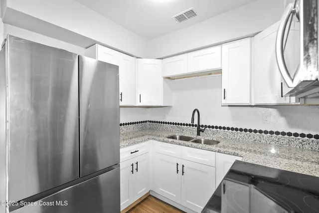 a kitchen with a sink and a refrigerator