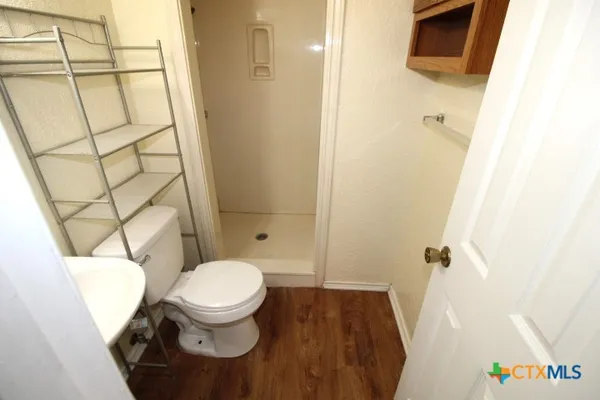 a bathroom with a toilet and a shower