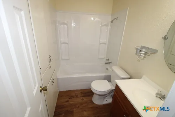 a white toilet sitting next to a bath tub