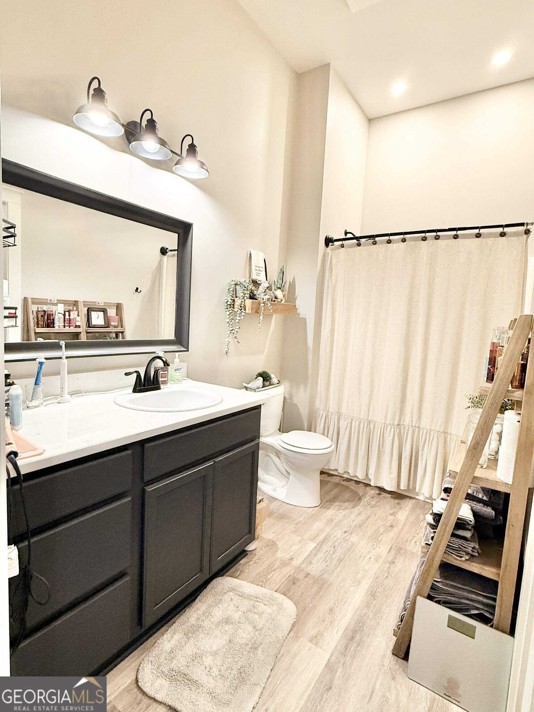 919 West Milner Road Concord, GA 30206 - Photo 34 of 40 a bathroom with a double vanity sink a mirror and a shower