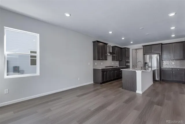 a view of kitchen with a refrigerator and wooden floor
