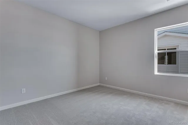a view of an empty room and closet area