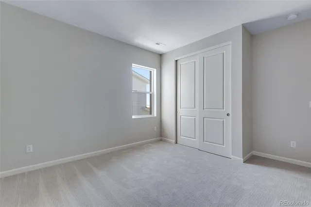 an empty room with windows and entrance