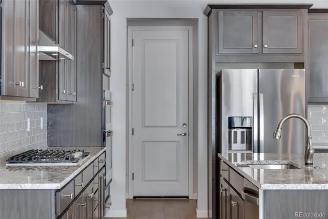 a kitchen with granite countertop a sink and cabinets