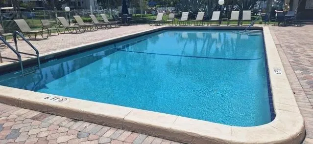 a living room with furniture flat screen tv and large window