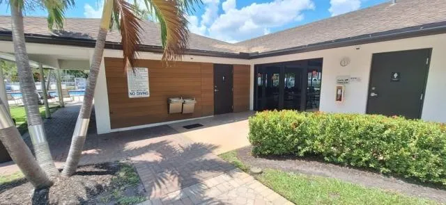 a backyard of a house with table and chairs