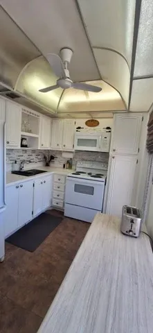 a kitchen with stainless steel appliances granite countertop a sink and cabinets