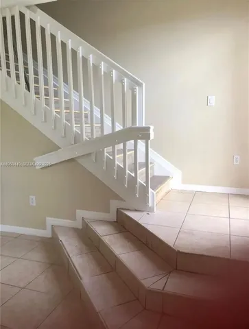 a view of staircase with white walls