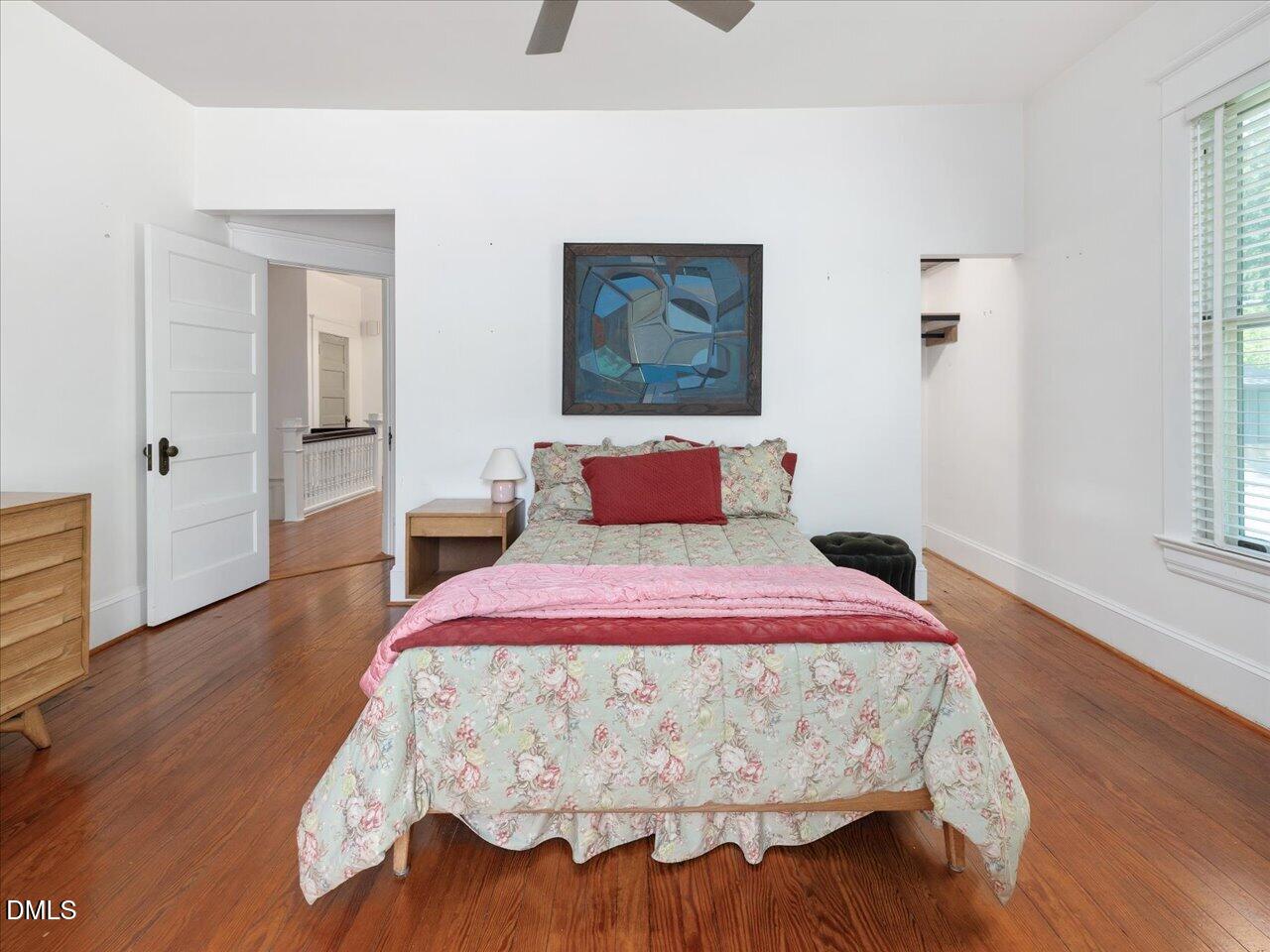 215 Hillcrest Road Raleigh, NC 27605 - Photo 82 of 97 a bedroom with a bed and wooden floor