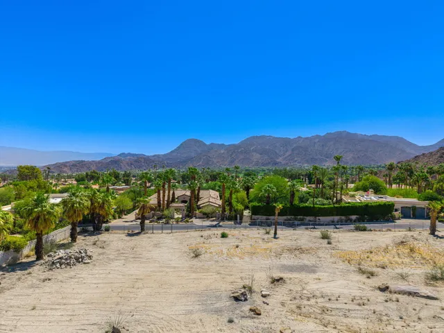 a view of a mountain with a yard
