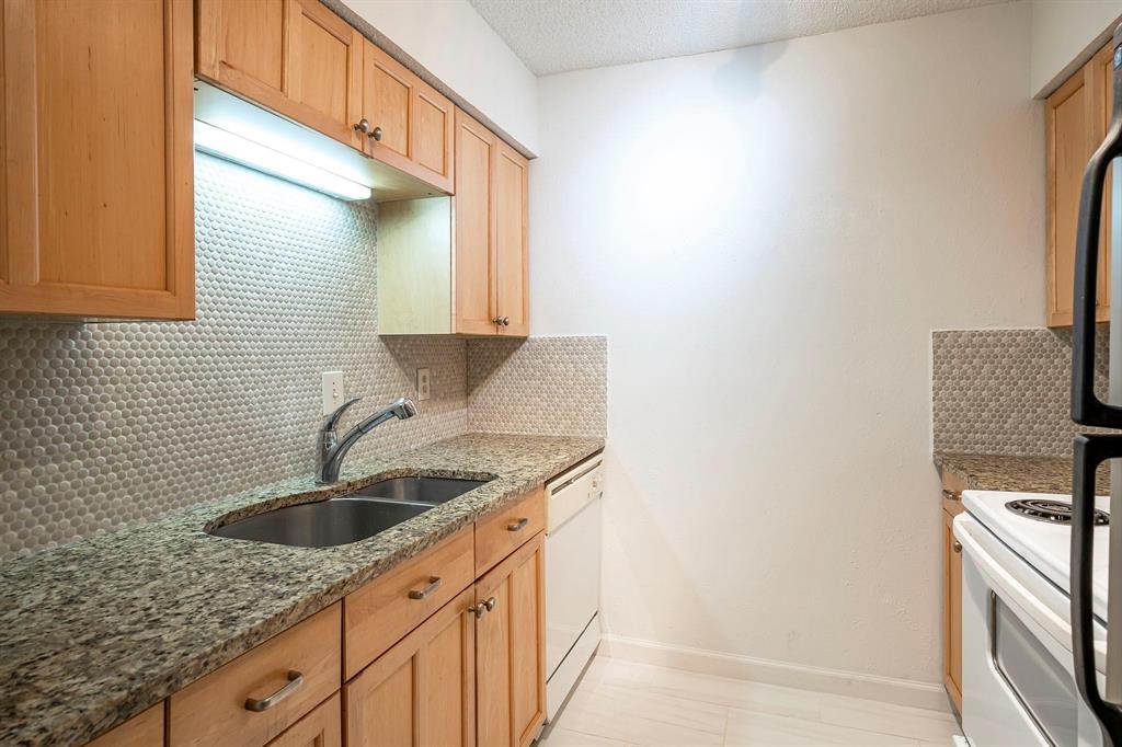 5812 Milton Street, Unit 105 Dallas, TX 75206 - Photo 4 of 12 a kitchen with stainless steel appliances granite countertop a sink and a granite counter tops with a double vanity