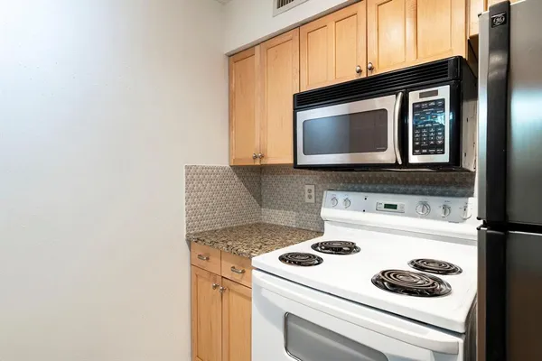 a kitchen with a stove and a microwave