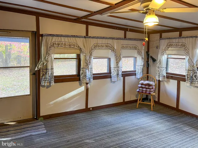 a view of a room with wooden floor