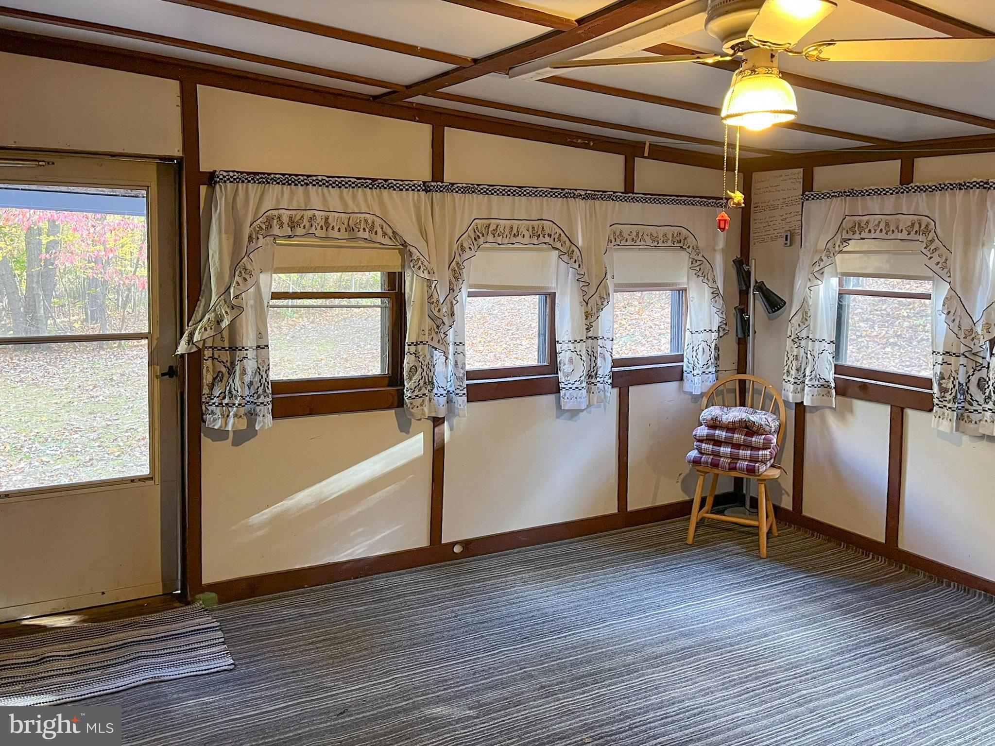9766 Valley View Road Three Springs, PA 17264 - Photo 11 of 40 a view of an empty room with wooden floor and windows