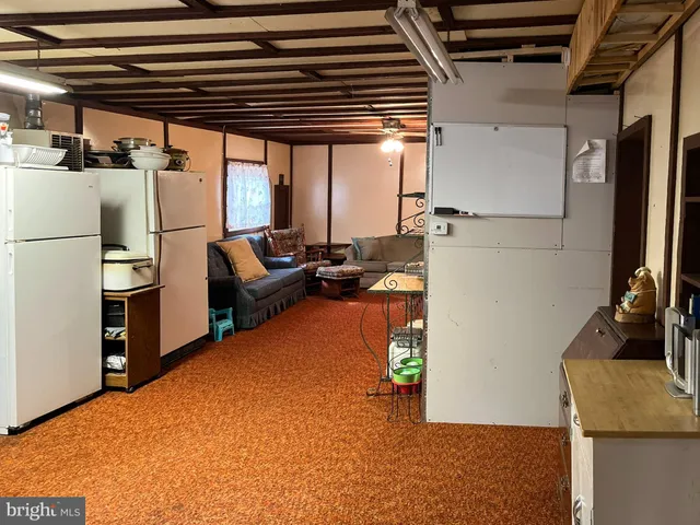 a view of kitchen with furniture and a refrigerator