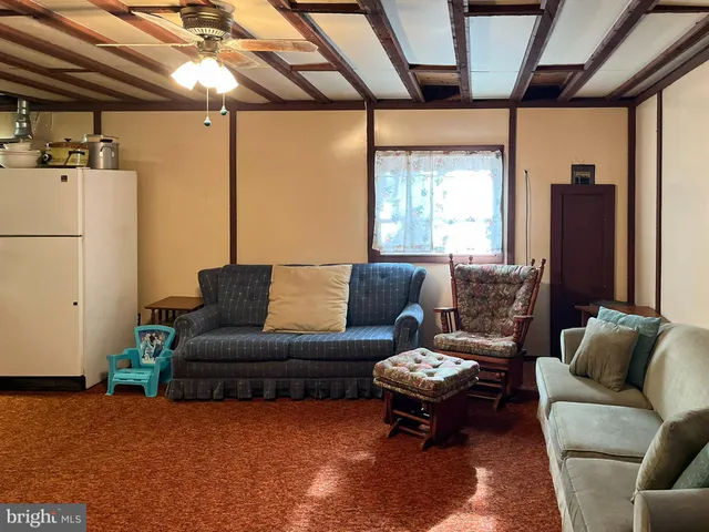 a living room with furniture and a dining table