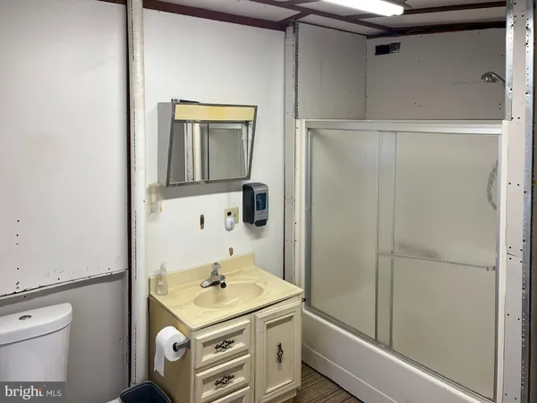 a bathroom with a toilet sink and shower