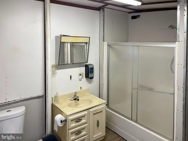 a bathroom with a toilet sink and shower