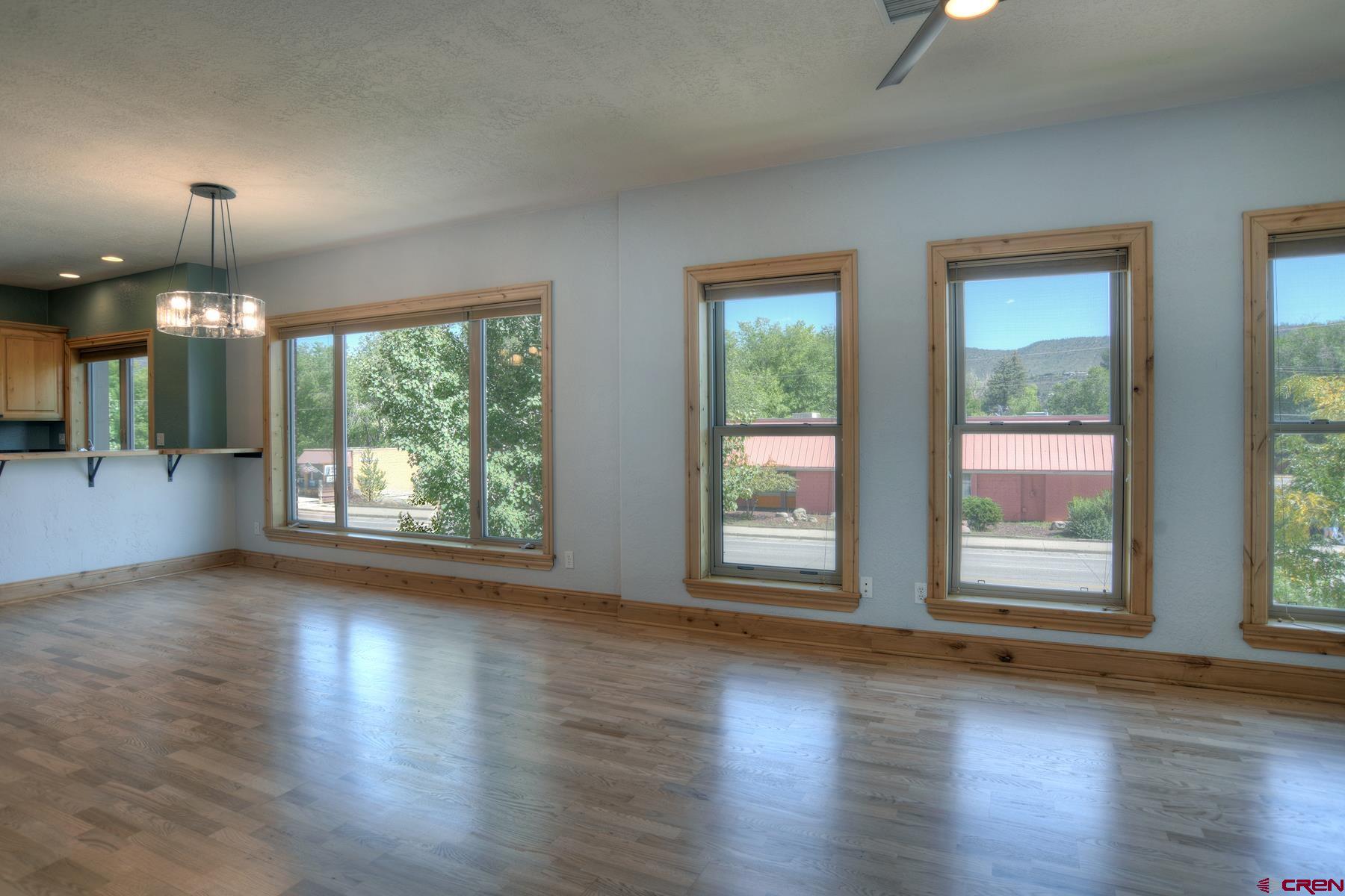 2855 Main Avenue, Unit A204 Durango, CO 81301 - Photo 12 of 45 an empty room with wooden floor exposed radiator and windows