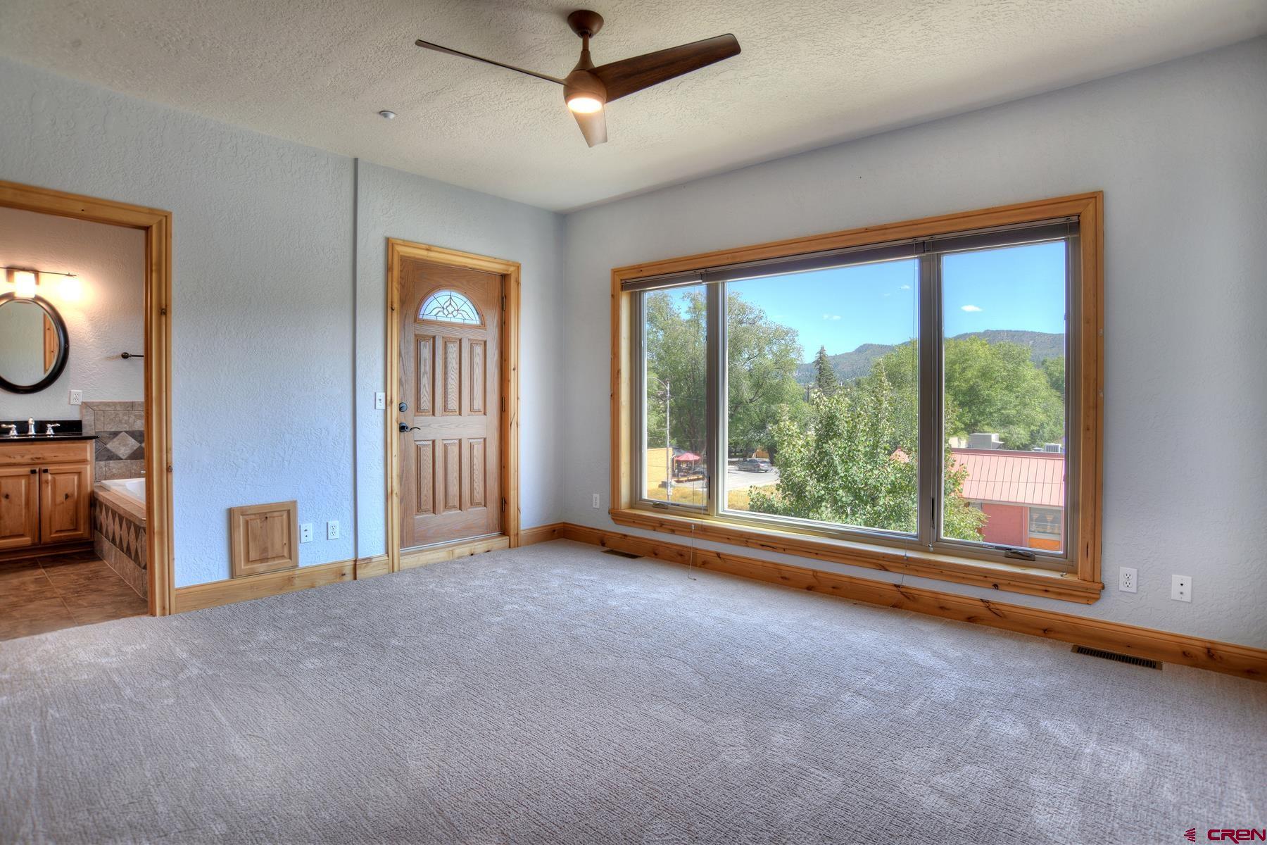 2855 Main Avenue, Unit A204 Durango, CO 81301 - Photo 15 of 45 a view of a livingroom with furniture window ceiling fan and windows