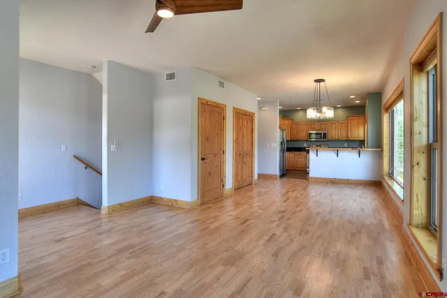 a view of a kitchen with wooden floor and a kitchen