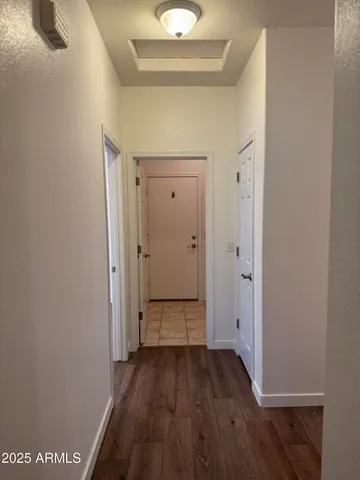 a view of a hallway with wooden floor