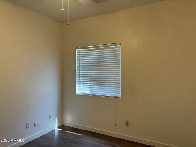 a view of a small space with wooden floor and a window