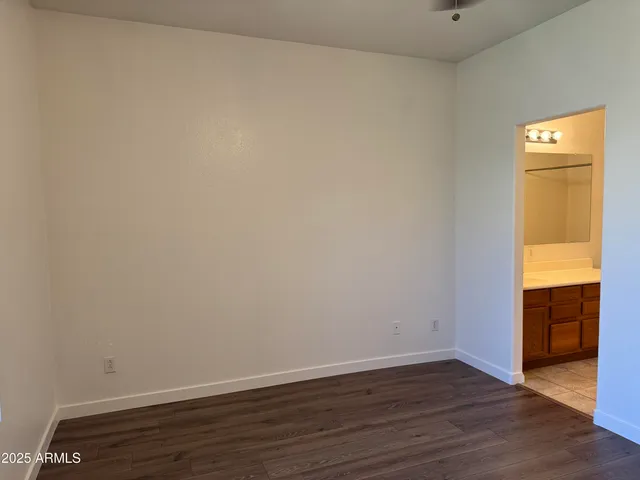 a view of an empty room and wooden floor