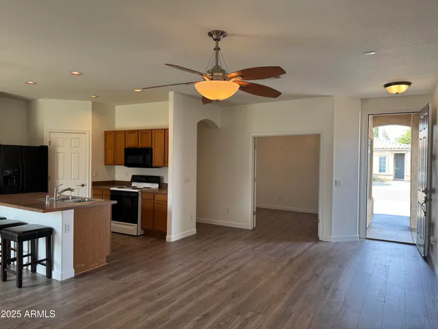 a dining room with wooden floor and a chandelier