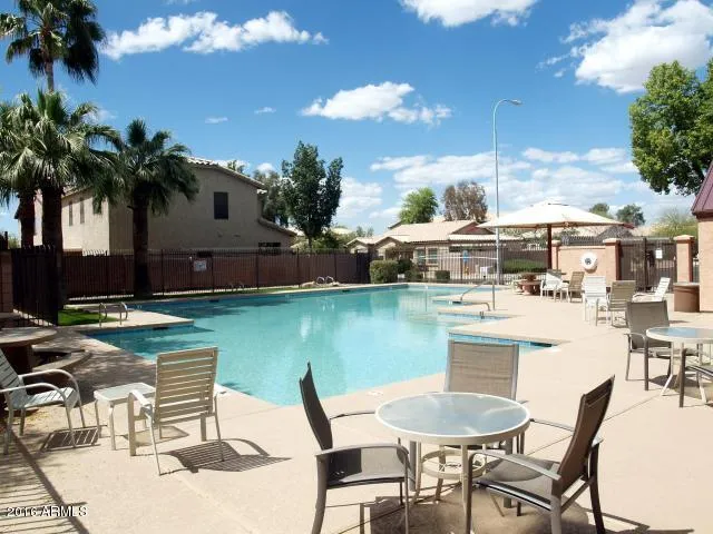 a view of a lake with a table and chairs