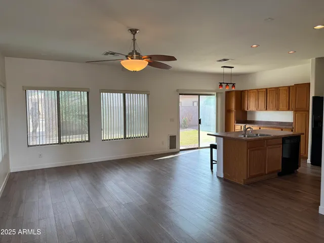 a view of kitchen with sink and wooden floor