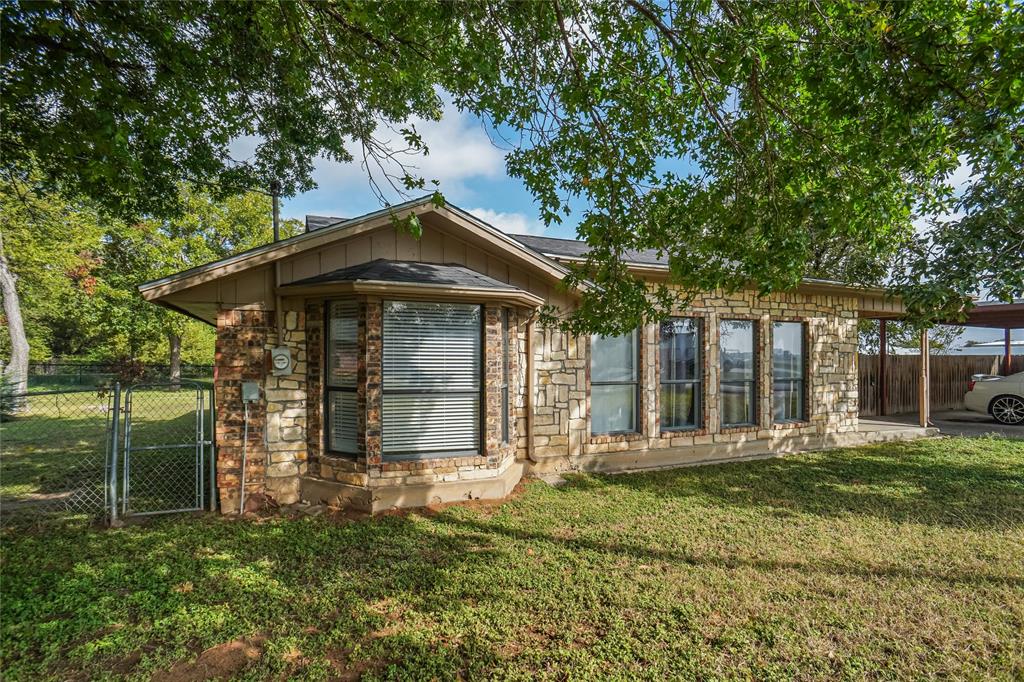 207 School House Road Paradise, TX 76073 - Photo 1 of 33 a front view of a house with a yard
