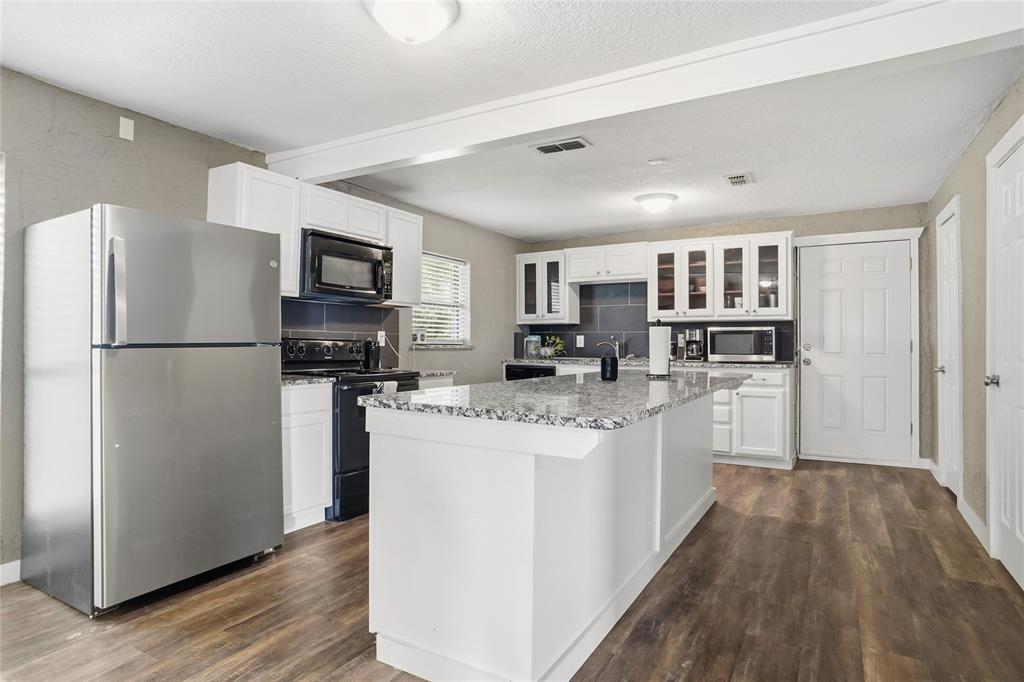 207 School House Road Paradise, TX 76073 - Photo 11 of 33 a kitchen with refrigerator and cabinets