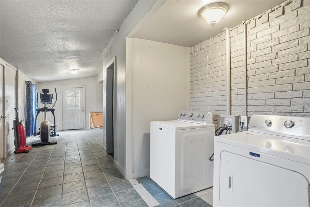 207 School House Road Paradise, TX 76073 - Photo 15 of 33 a view of storage and utility room with washer and dryer