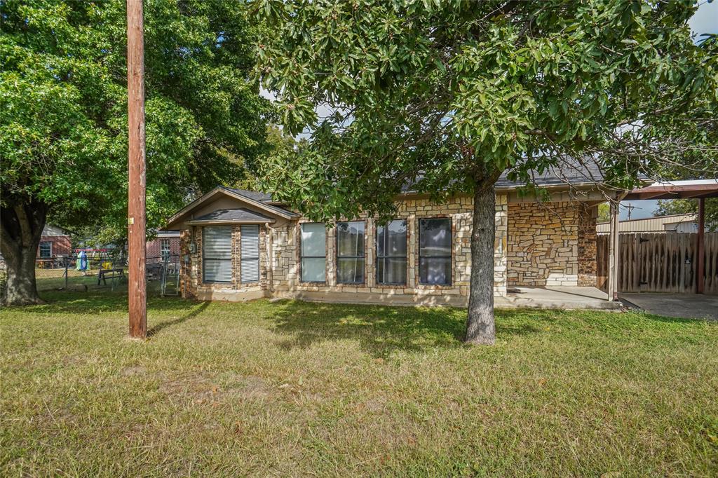 207 School House Road Paradise, TX 76073 - Photo 2 of 33 a house with trees in the background